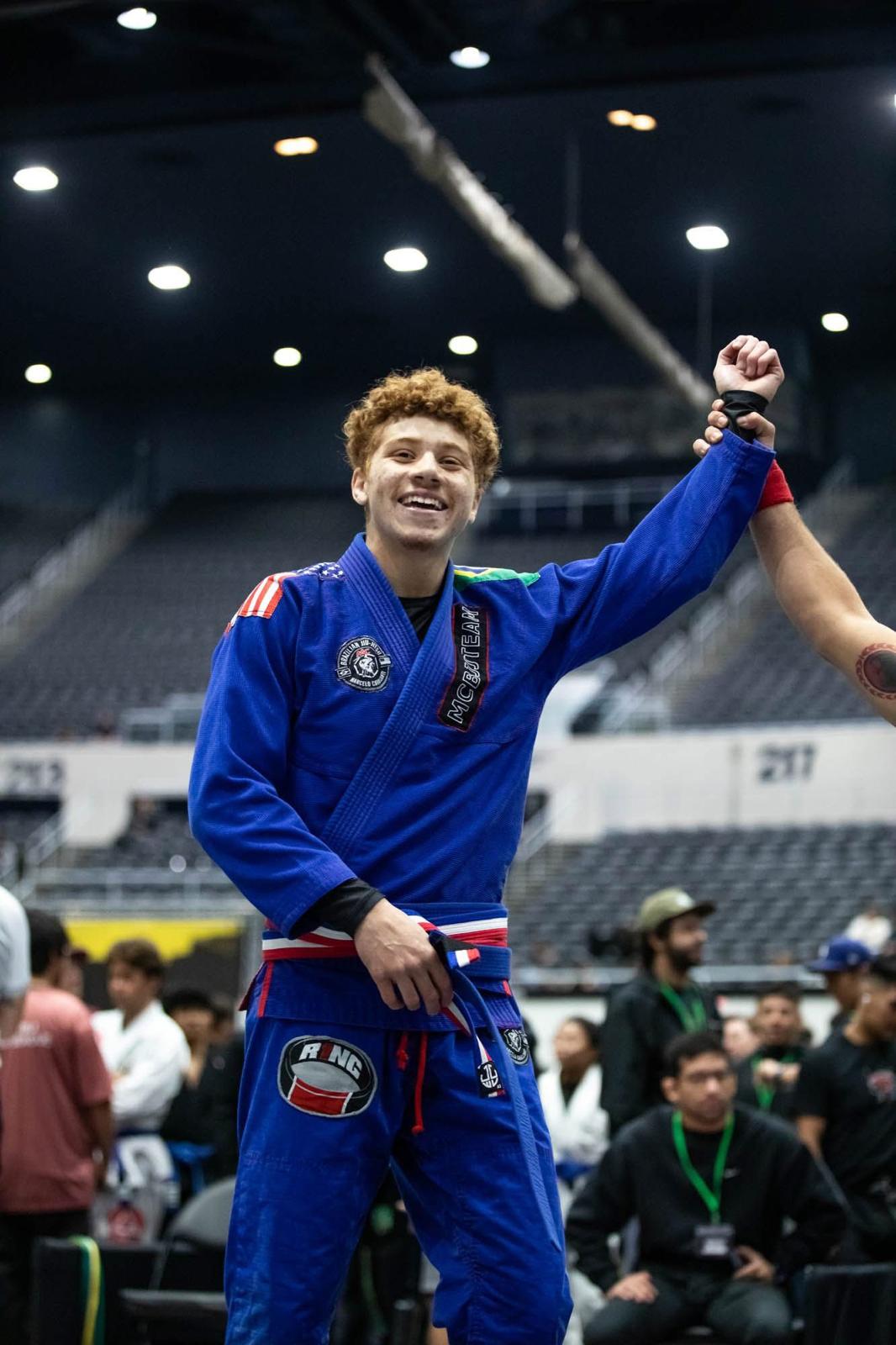MCBJJ student winning BJJ competition arm raised in victory