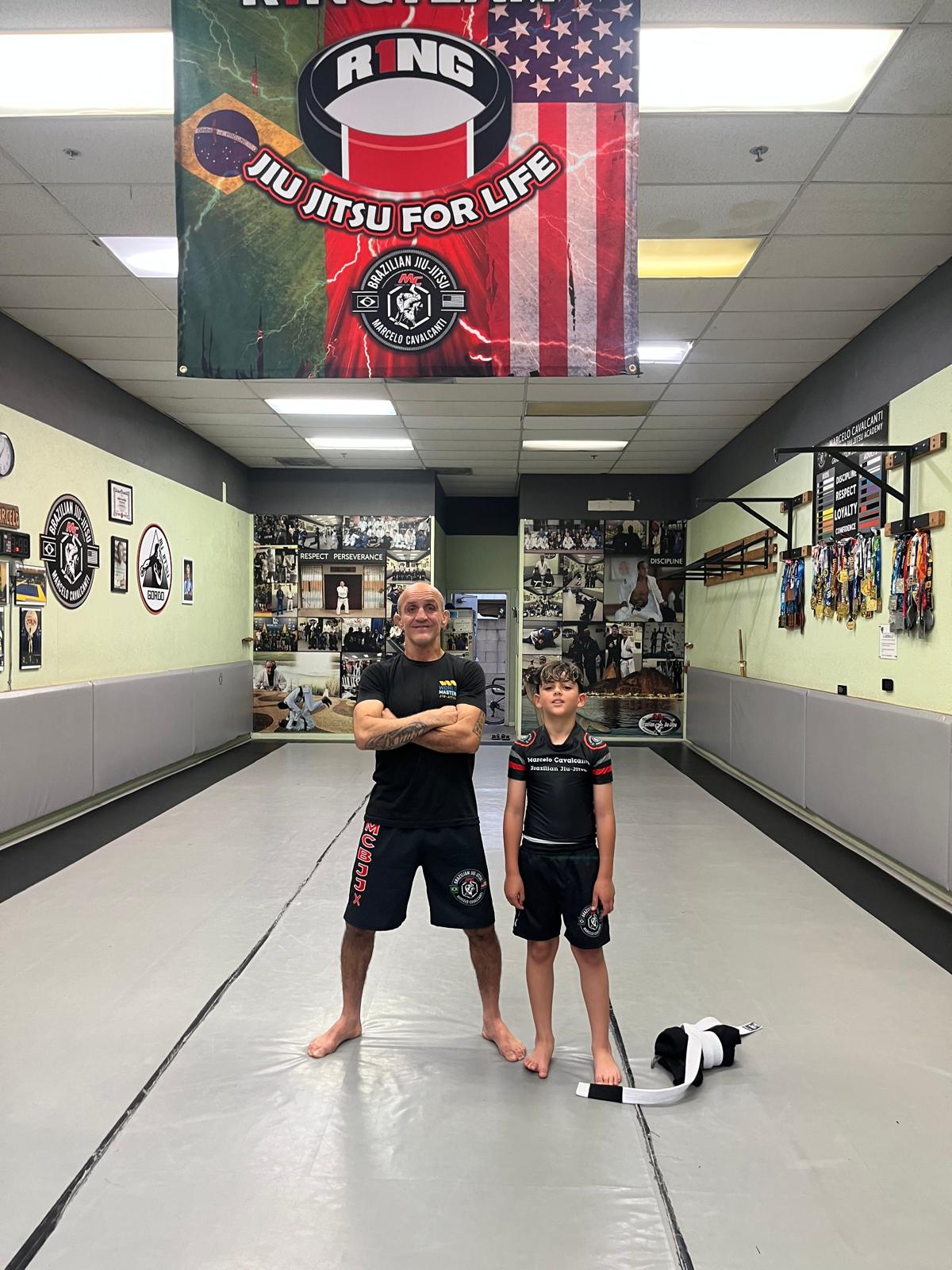 MCBJJ instructor with young student on the mat