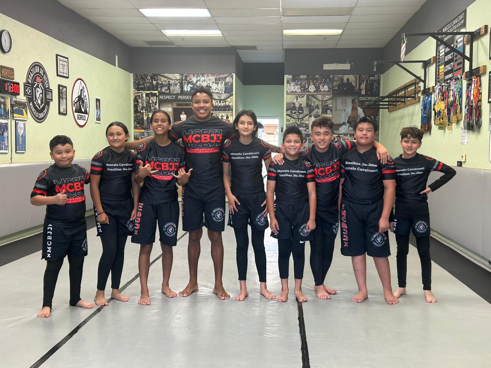 MCBJJ No-Gi kids team in black and red rashguards